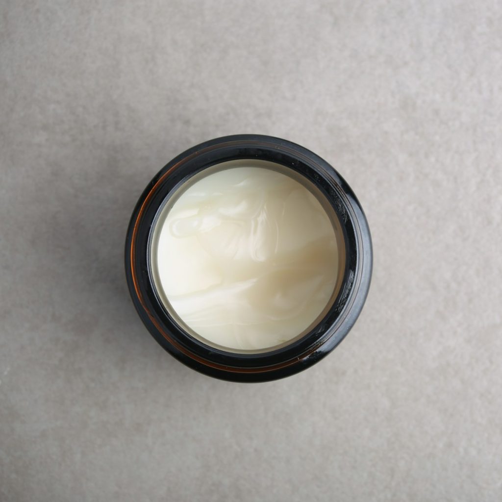 a jar of cream sitting on top of a table
